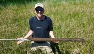 Smithsonian biogeochemist Pat Megonigal holds up a soil core. Scientists collected data from nearly 2,000 wetland soil cores to estimate how much carbon wetlands in the continental U.S. can store. (Photo: SERC)
