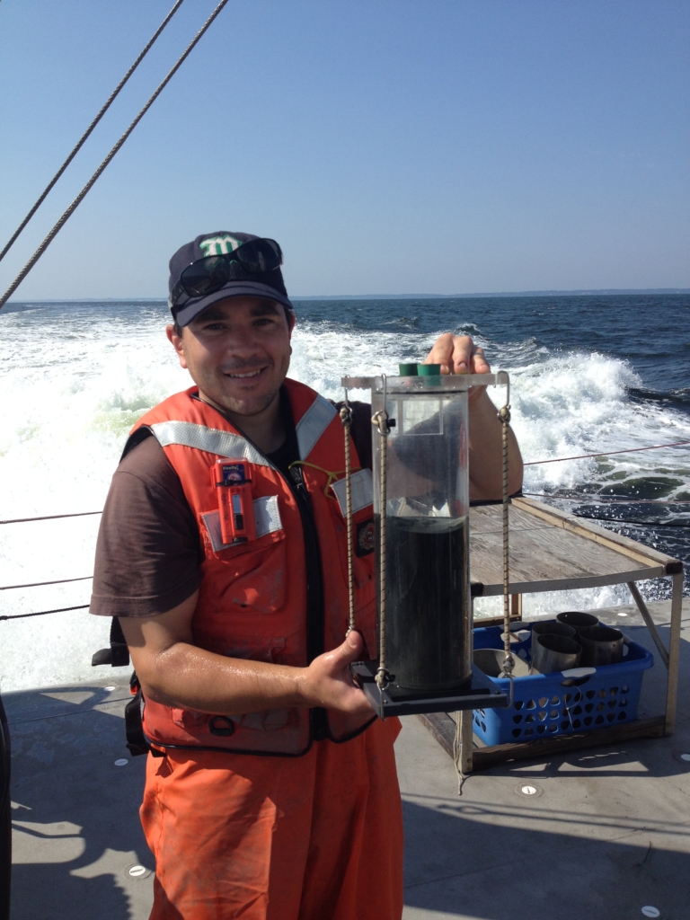 Jeremy Testa holding a sediment core from the anoxic mid-Bay region. The blackish-grey sediments, usually a brown-orange color at the surface, are depleted of oxygen. 